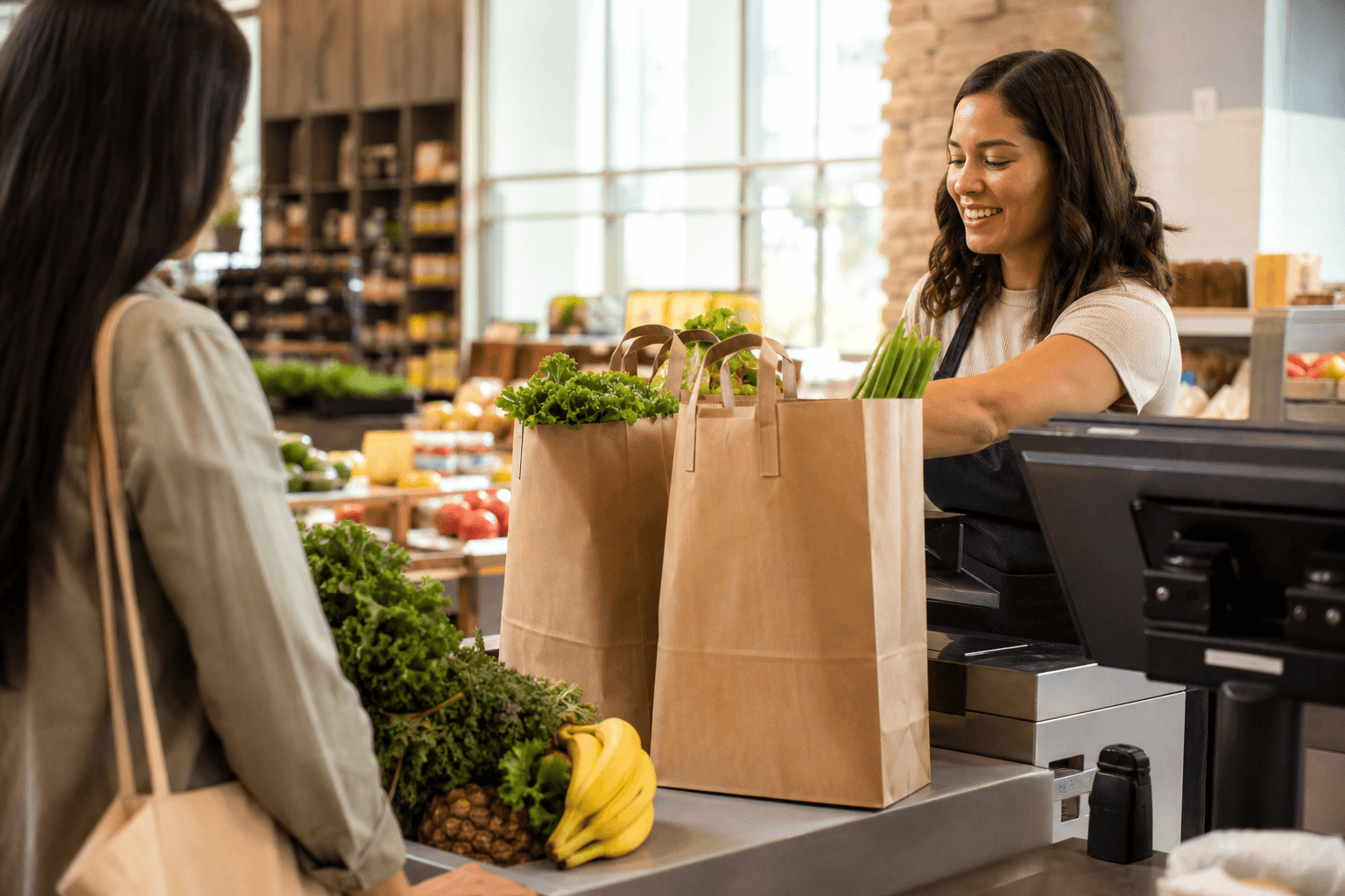 Compostable carry bags at a grocery checkout